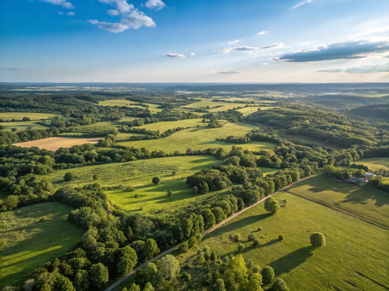 Aerial photograph of a vast, undeveloped plot of land, showcasing its potential for future development and strategic location.